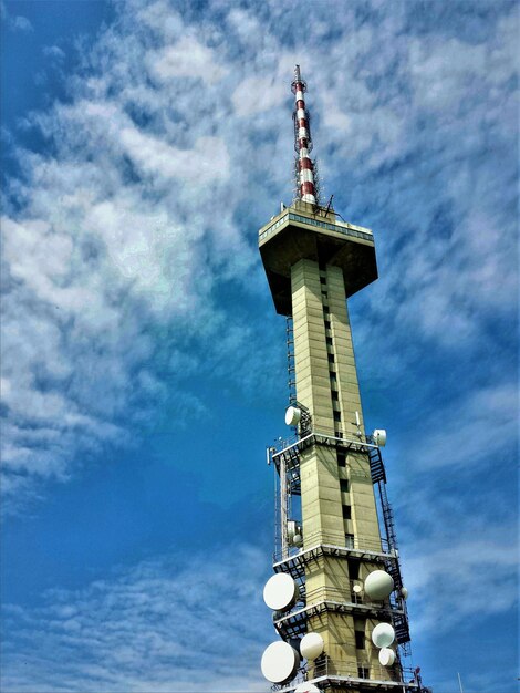 Low angle view of communications tower against sky