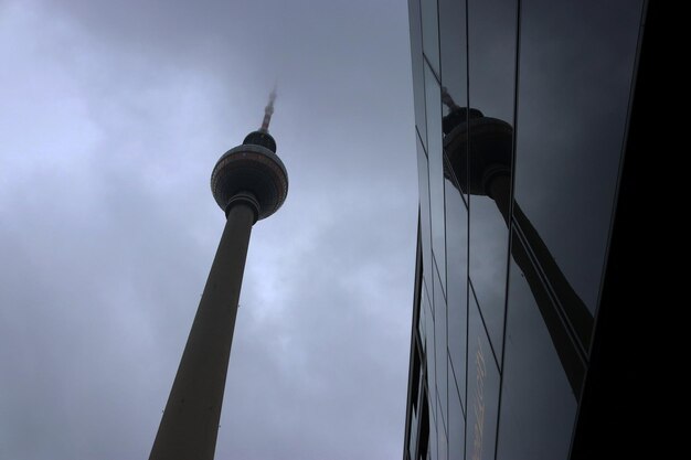 Low angle view of communications tower against sky