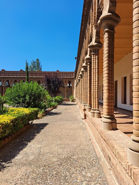 Low angle view of a covent cloister against clear blue sky barcelona spain