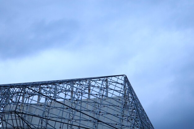 Low angle view of crane against blue sky