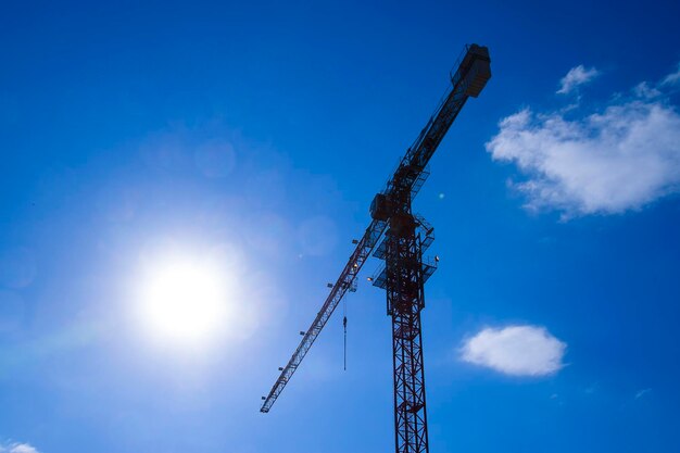 Low angle view of crane against blue sky