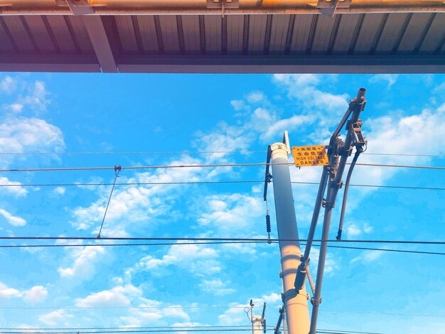 Low angle view of crane against blue sky