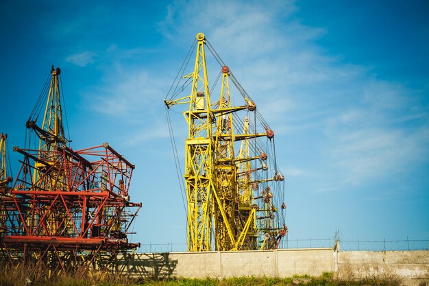 Low angle view of crane against blue sky