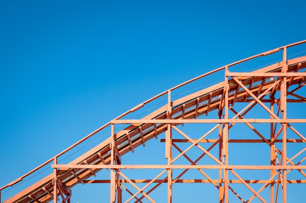 Low angle view of crane against clear blue sky