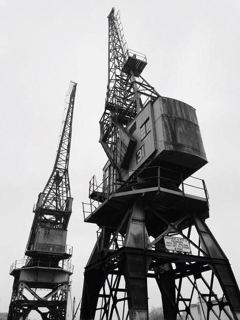 Low angle view of crane against clear sky