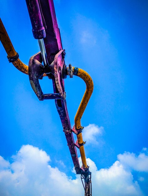 Low angle view of crane against sky