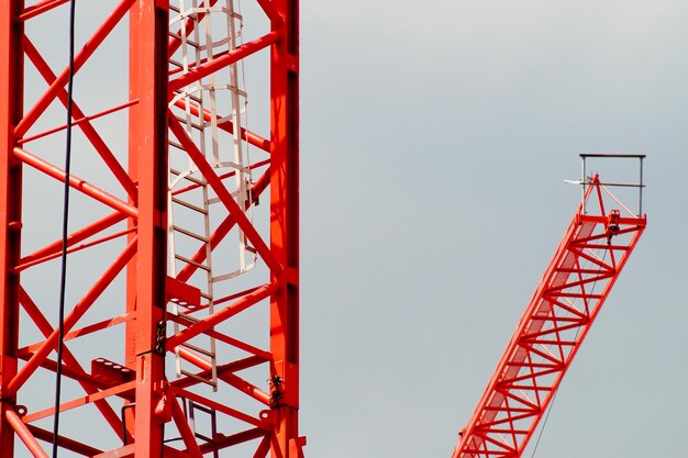 Low angle view of crane against sky