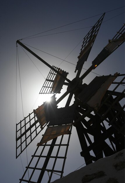 Low angle view of crane against sky