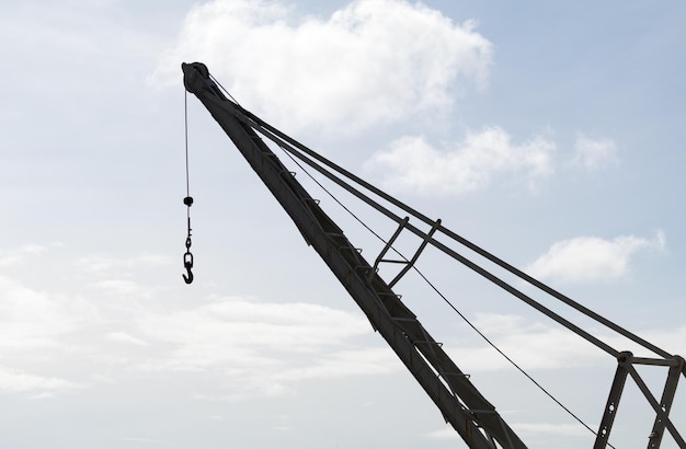 Low angle view of crane against sky