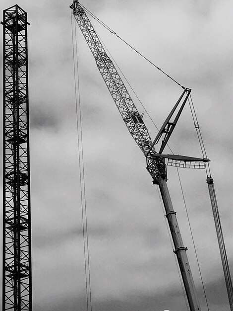 Low angle view of crane against sky