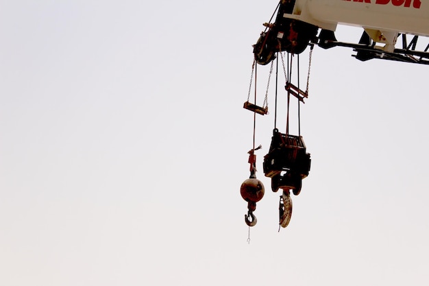 Low angle view of crane against sky