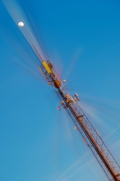 Low angle view of cranes against sky