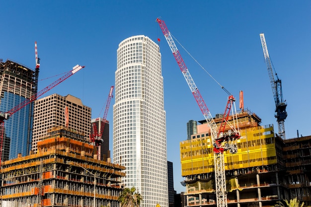 Low angle view of cranes and incomplete buildings