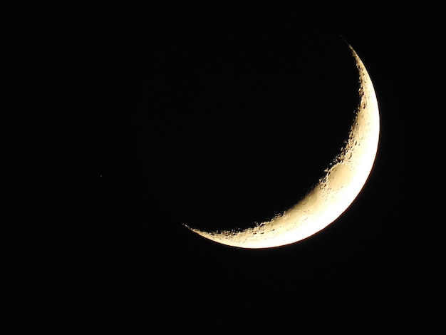 Low angle view of crescent moon at night