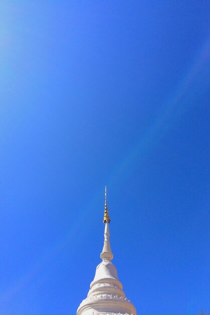 Low angle view of cross against blue sky