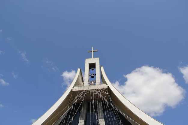 Low angle view of cross on building against sky