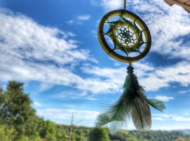 Low angle view of cross hanging against sky