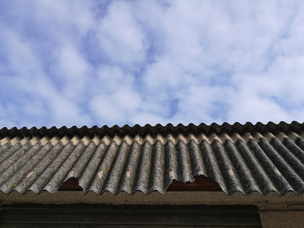 Low angle view of damaged roof against sky