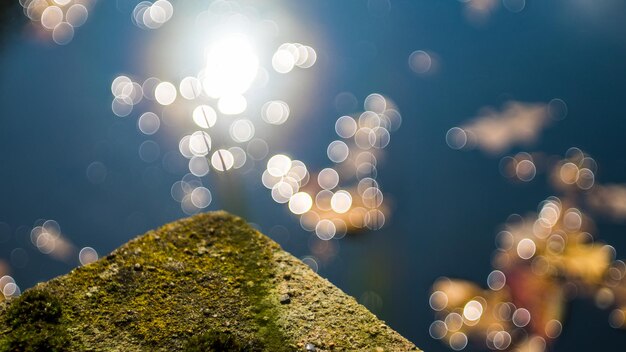 Low angle view of defocused lights against sky at night