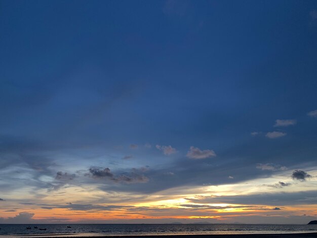 Low angle view of dramatic sky over sea during sunset