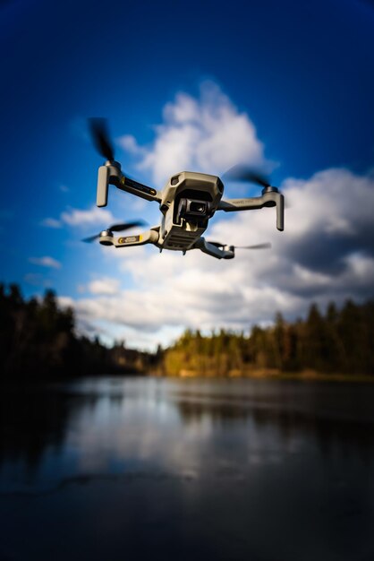 Low angle view of drone  flying against blue sky