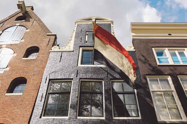 Low angle view of dutch flag on building during king day