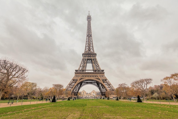 low angle view of eiffel tower against cloudy sky