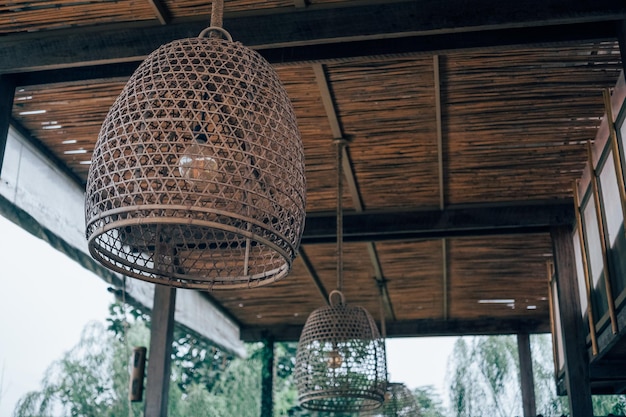 Low angle view of electric lamp hanging on ceiling of building