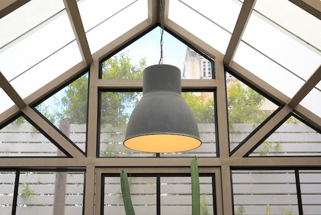 low angle view of electric lamp hanging on ceiling in building