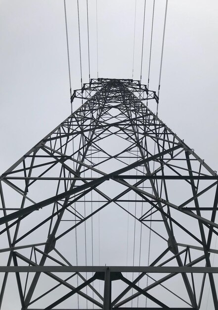 Low angle view of electricity pylon against clear sky