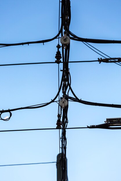 Low angle view of electricity pylon against clear sky