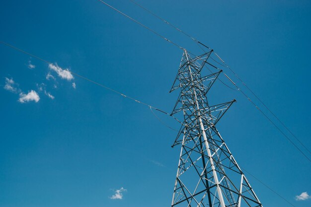 Low angle view of electricity pylon against clear sky