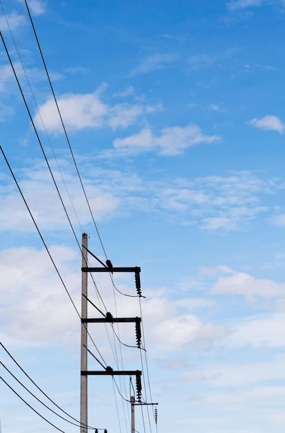 Low angle view of electricity pylon against cloudy sky