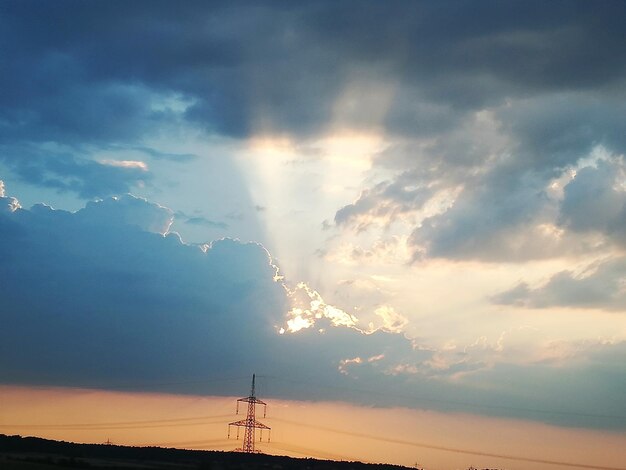Photo low angle view of electricity pylon against sky during sunset