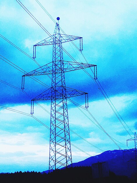 Low angle view of electricity pylon against sky