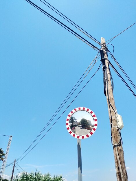 Low angle view of electricity pylon against sky