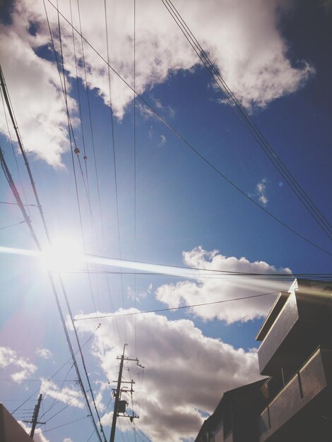 Low angle view of electricity pylon against sky