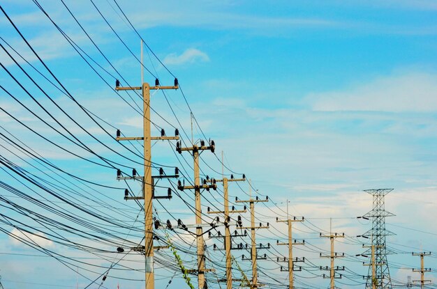 Low angle view of electricity pylon against sky