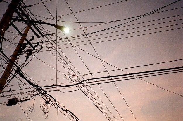 Low angle view of electricity pylon against sky