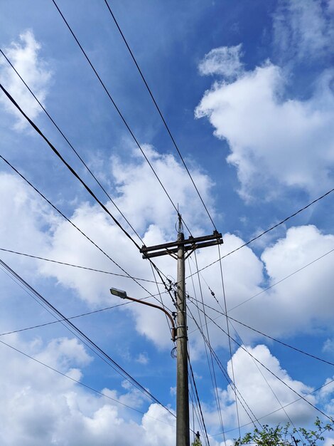 Low angle view of electricity pylon against sky