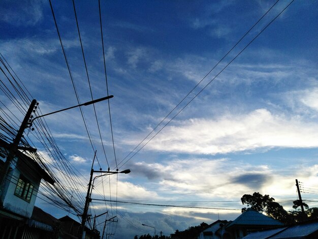 Low angle view of electricity pylon against sky