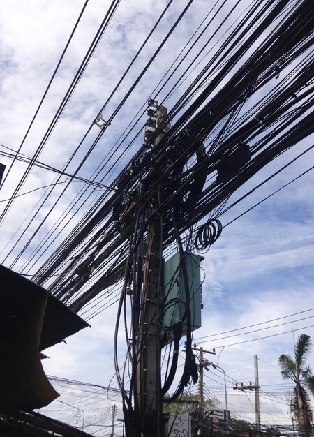 Low angle view of electricity pylon against sky