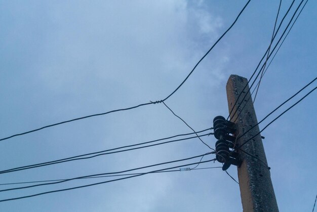 Low angle view of electricity pylon against sky