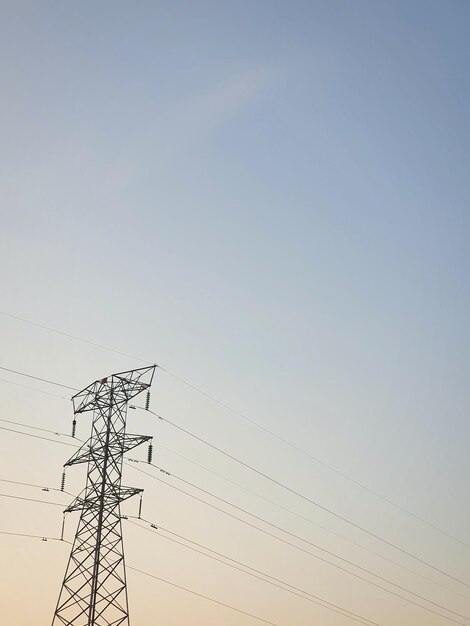 Low angle view of electricity pylon against sky