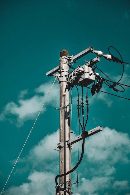 Low angle view of electricity pylon against sky