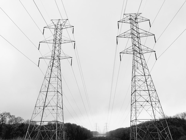low angle view of electricity pylons against clear sky