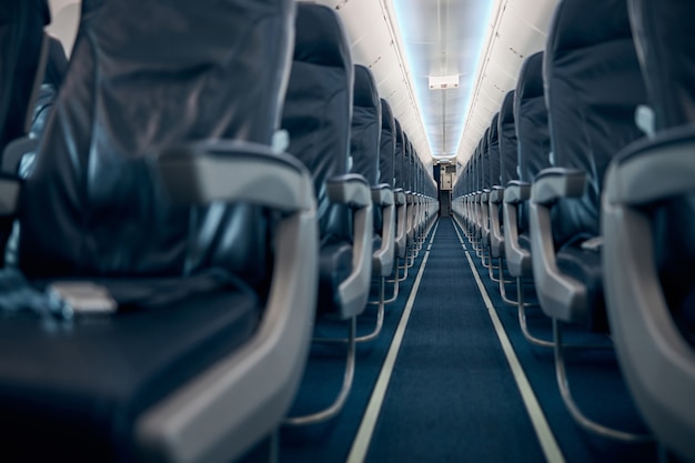 Low angle view of empty chairs in economy class aircraft of civil aviation