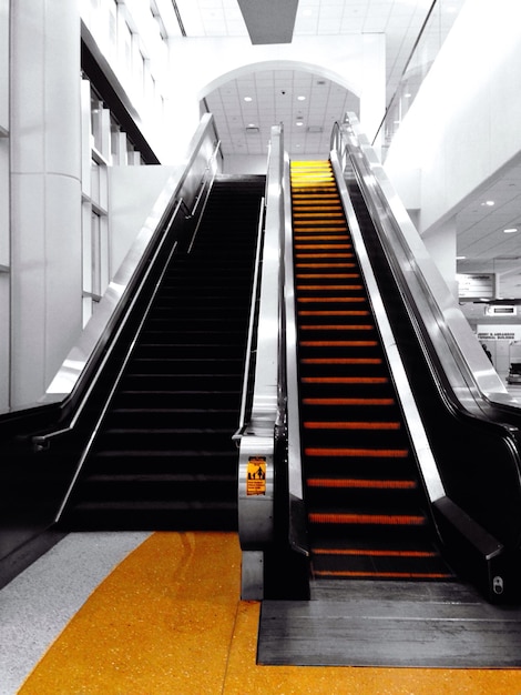 Low angle view of escalators at airport