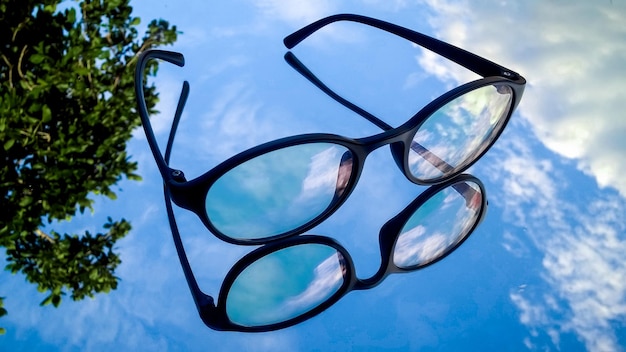 Low angle view of eyeglasses against sky