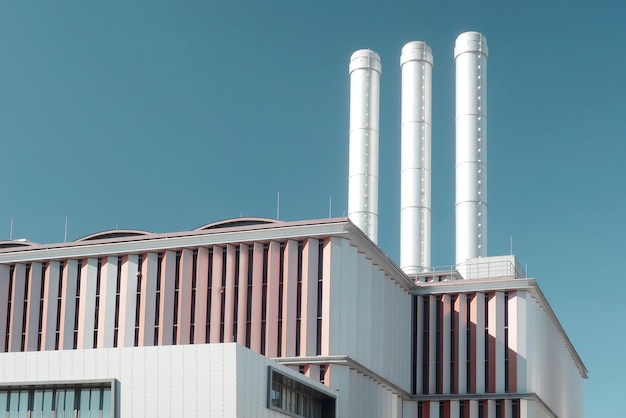Low angle view of factory against clear blue sky
